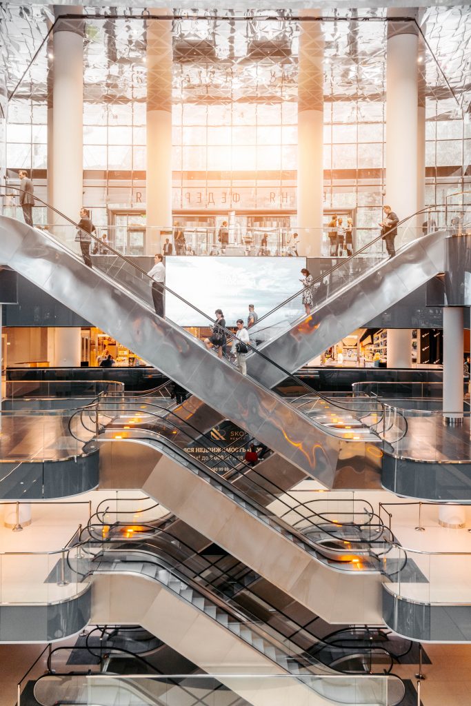 people using shopping centre escalators